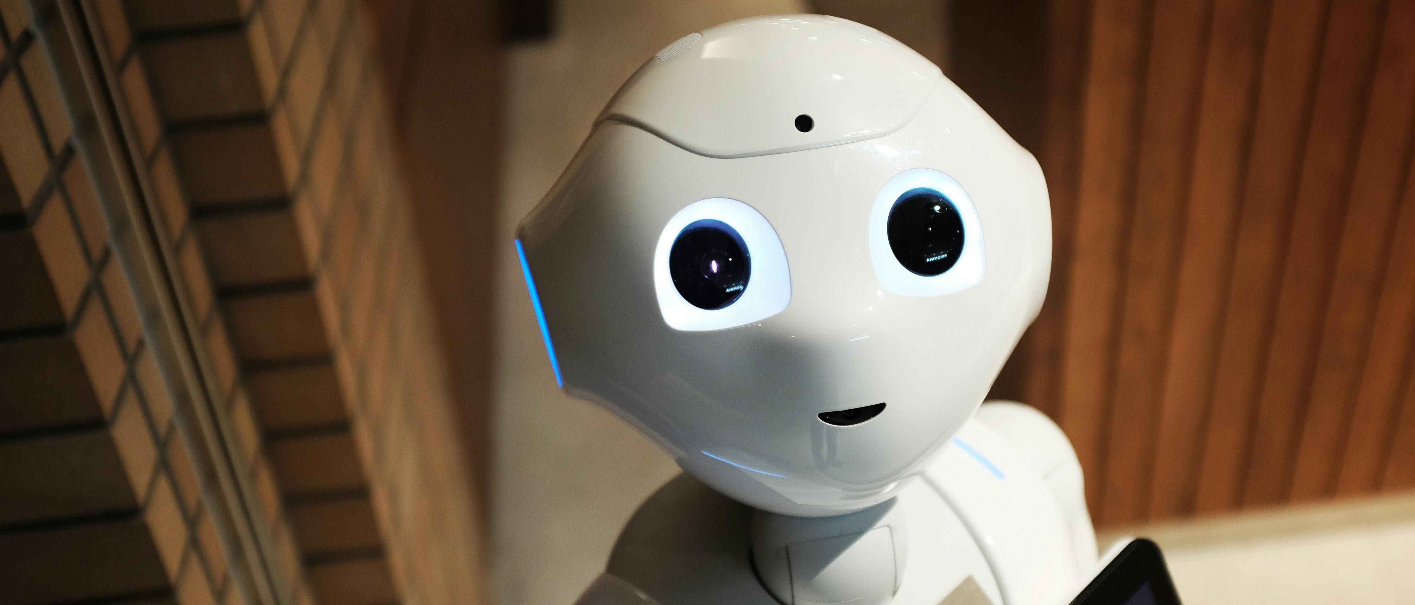 a friendly robot with big eyes looking into the camera
